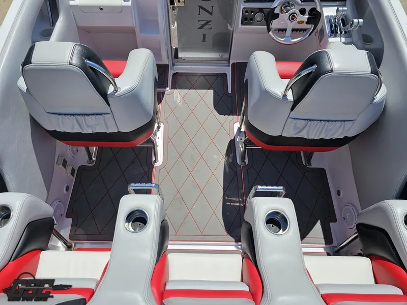 Slide: The Image of 2007 Donzi 38 ZR interior with red and gray seating, steering wheel, and cup holders. - 48