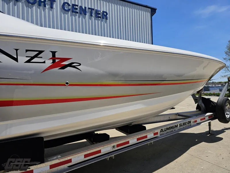 Slide: The Image of 2007 Donzi 38 ZR boat on trailer, side view with vibrant stripes. - 6