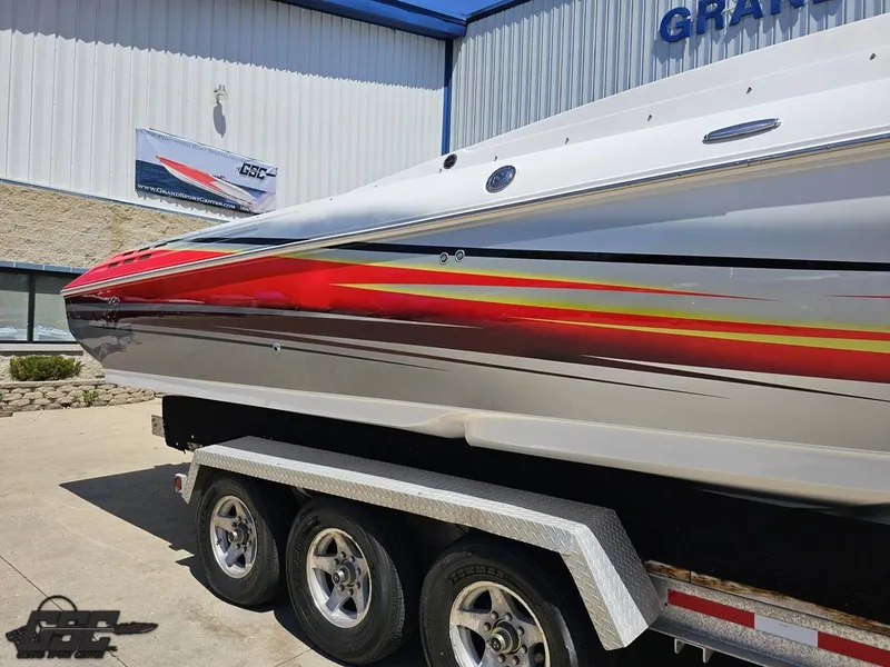 Slide: The Image of 2007 Donzi 38 ZR boat with vibrant red and yellow stripes on a trailer. - 7