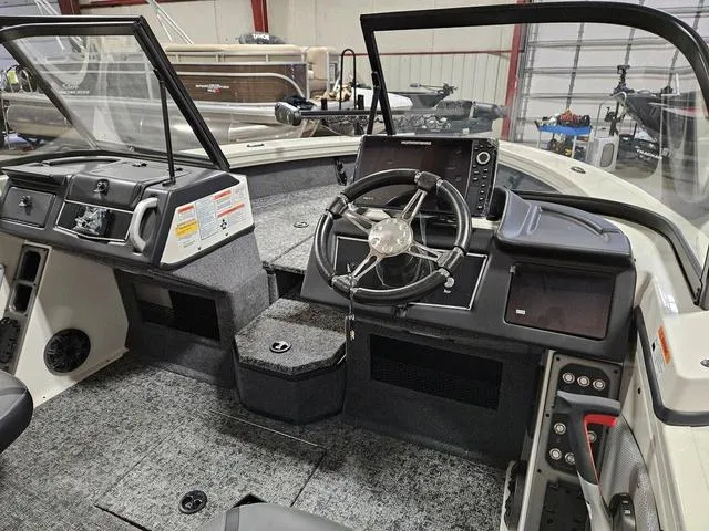Slide: The Image of Interior of 2025 Ranger VX1988 WT boat, featuring steering wheel and control panel. - 3