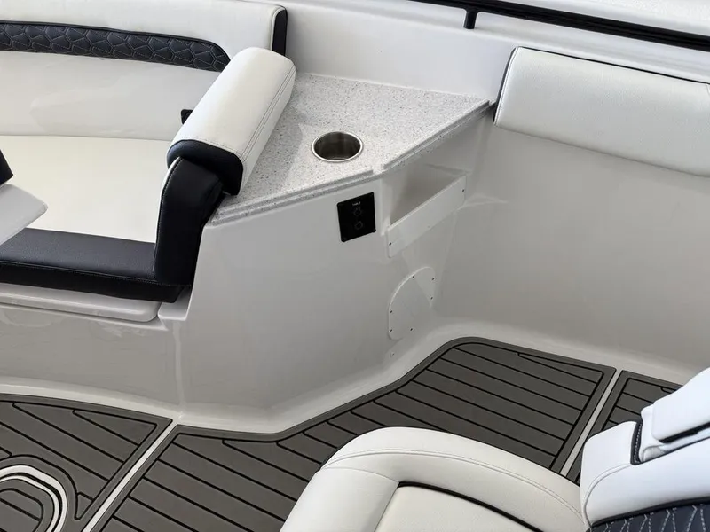 Slide: The Image of 2025 Tidewater 282 CC Adventure boat interior with seating and cup holder. - 10