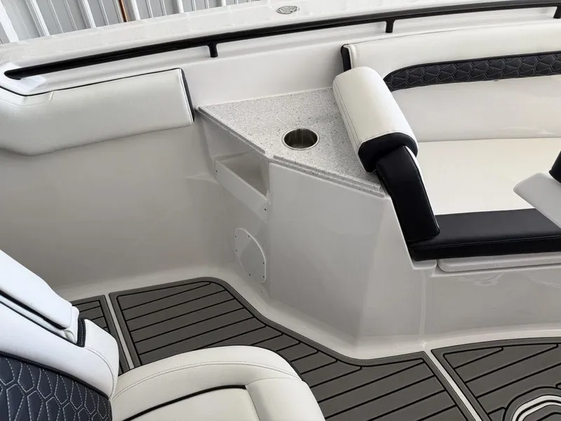 Slide: The Image of 2025 Tidewater 282 CC Adventure boat interior with cushioned seating and cup holder. - 11