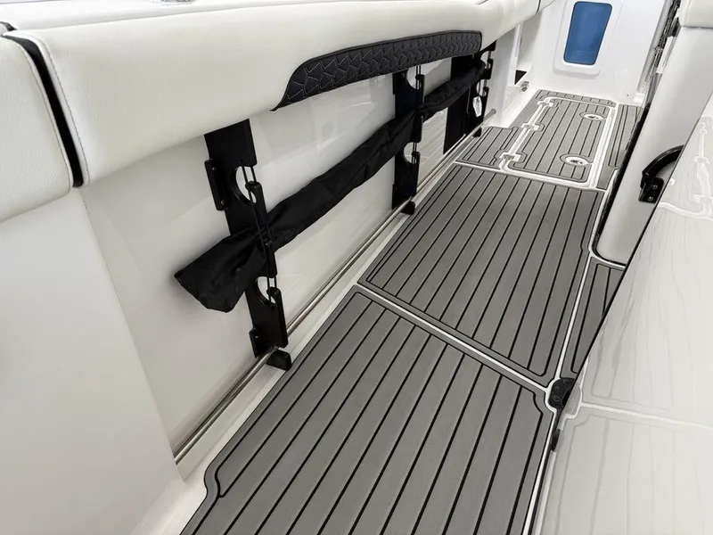 Slide: The Image of 2025 Tidewater 282 CC Adventure boat interior with sleek, modern flooring and secure storage features. - 17