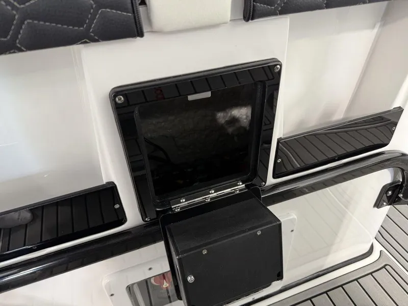 Slide: The Image of 2025 Tidewater 282 CC Adventure boat interior with storage compartments and sleek design. - 19