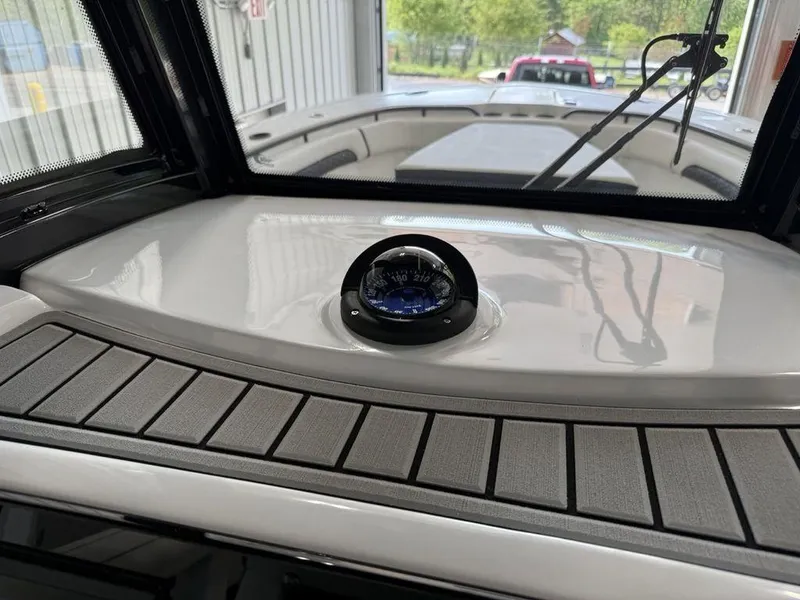 Slide: The Image of 2025 Tidewater 282 CC Adventure boat interior with compass and windshield view. - 21