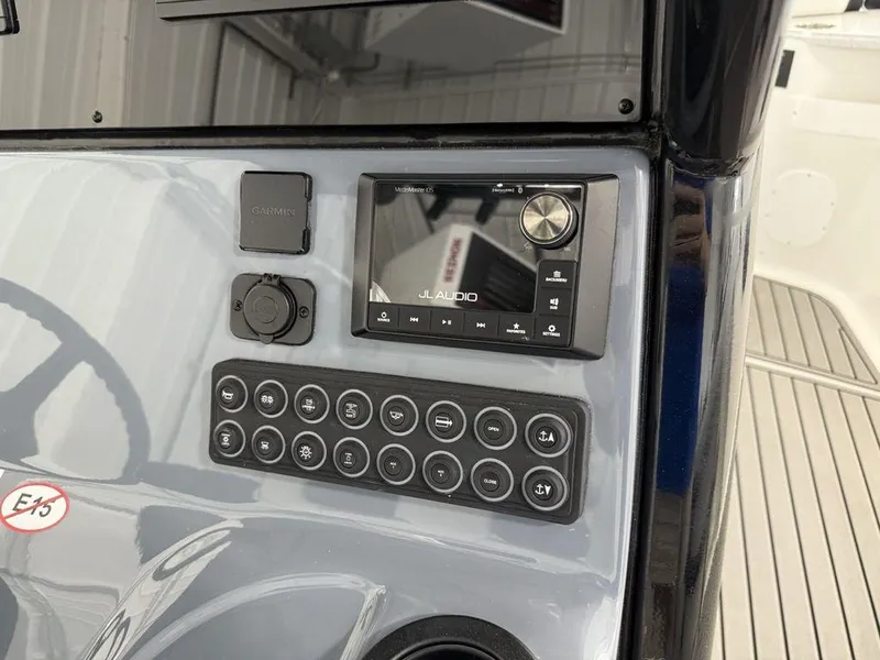 Slide: The Image of Control panel of 2025 Tidewater 282 CC Adventure boat with JL Audio system. - 22