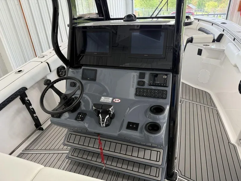 Slide: The Image of 2025 Tidewater 282 CC Adventure boat cockpit with dual screens and modern controls. - 23