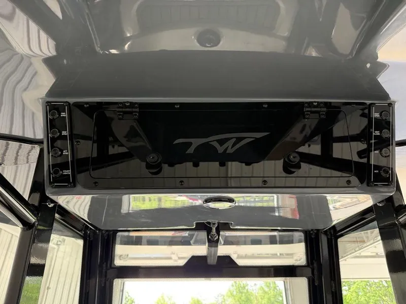 Slide: The Image of 2025 Tidewater 282 CC Adventure boat console with sleek black design and modern controls. - 25