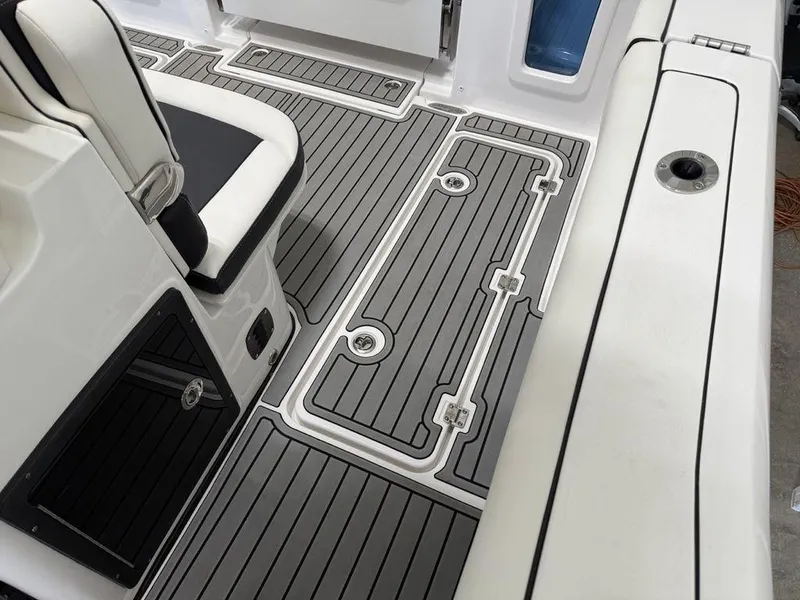 Slide: The Image of 2025 Tidewater 282 CC Adventure boat interior with sleek, modern deck design and seating. - 27