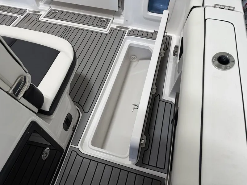 Slide: The Image of 2025 Tidewater 282 CC Adventure boat interior with open storage compartment and sleek flooring. - 28