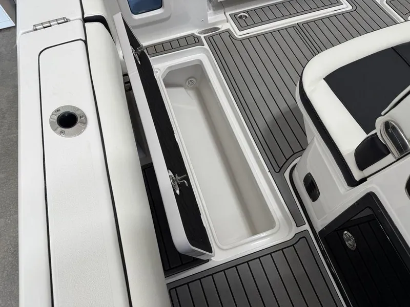 Slide: The Image of 2025 Tidewater 282 CC Adventure boat interior with open storage compartment and sleek design. - 29