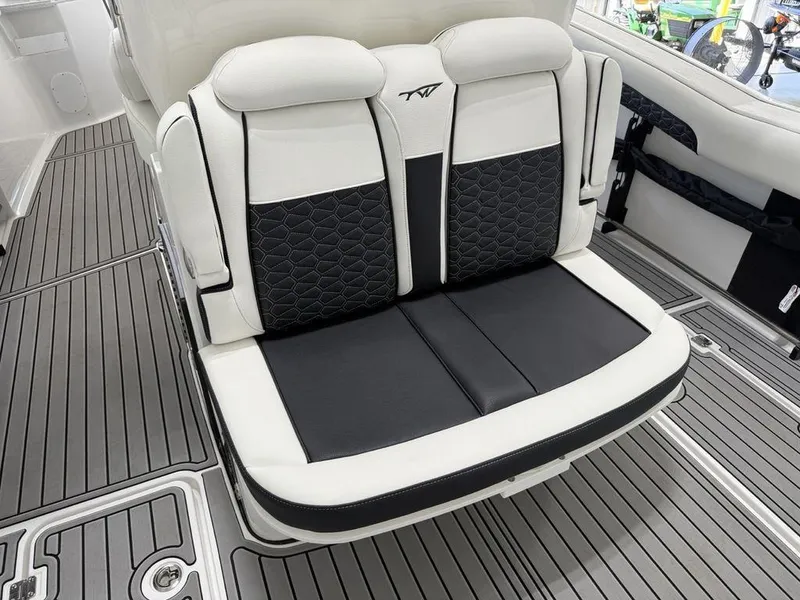 Slide: The Image of 2025 Tidewater 282 CC Adventure boat seating with black and white upholstery. - 30