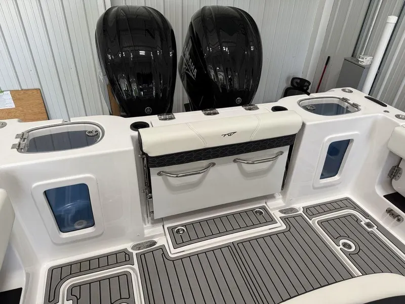 Slide: The Image of 2025 Tidewater 282 CC Adventure boat deck with dual engines and storage compartments. - 31
