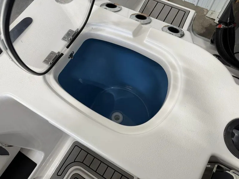 Slide: The Image of Livewell on 2025 Tidewater 282 CC Adventure boat, featuring rod holders and non-slip flooring. - 32