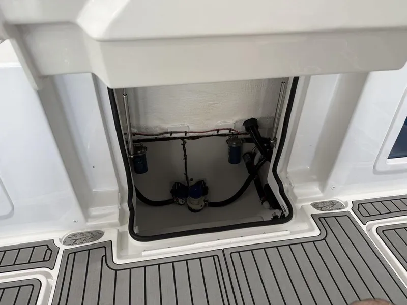Slide: The Image of 2025 Tidewater 282 CC Adventure boat interior compartment with visible wiring and components. - 33