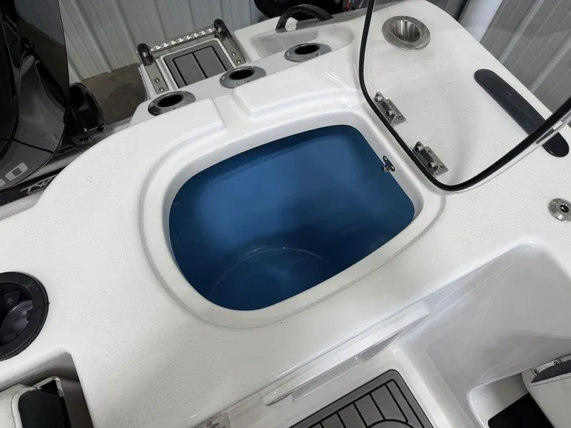Slide: The Image of 2025 Tidewater 282 CC Adventure boat livewell with rod holders and cup holder. - 34
