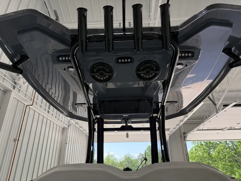 Slide: The Image of 2025 Tidewater 282 CC Adventure boat, interior view of T-top with rod holders and speakers. - 35