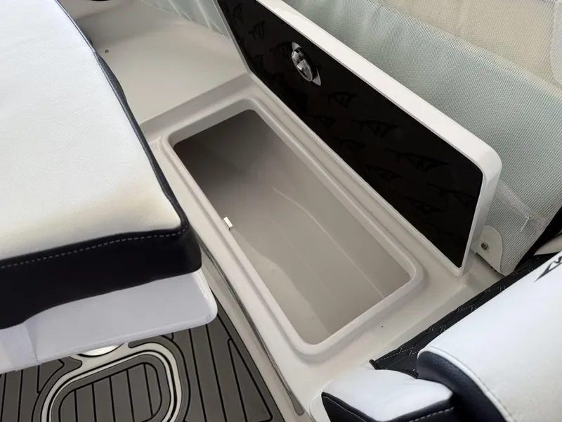 Slide: The Image of 2025 Tidewater 282 CC Adventure boat storage compartment with cushioned seating and sleek design. - 6