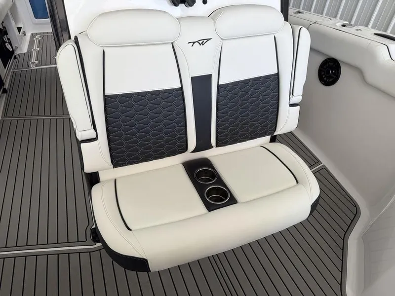 Slide: The Image of 2025 Tidewater 282 CC Adventure boat seat with cup holders, featuring elegant black and white design. - 9