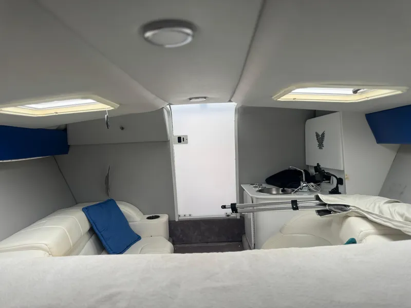 Slide: The Image of Interior of 2000 Formula 271 FASTech boat with white seating and compact kitchenette. - 12