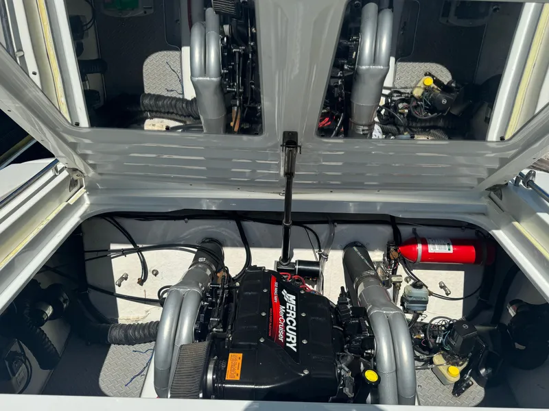 Slide: The Image of Engine compartment of a 2000 Formula 271 FASTech boat with Mercury engine and fire extinguisher. - 13