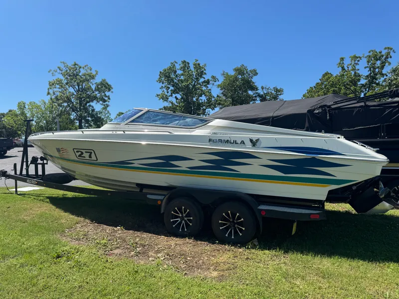Slide: The Image of 2000 Formula 271 FASTech boat on trailer, parked on grass under clear sky. - 2