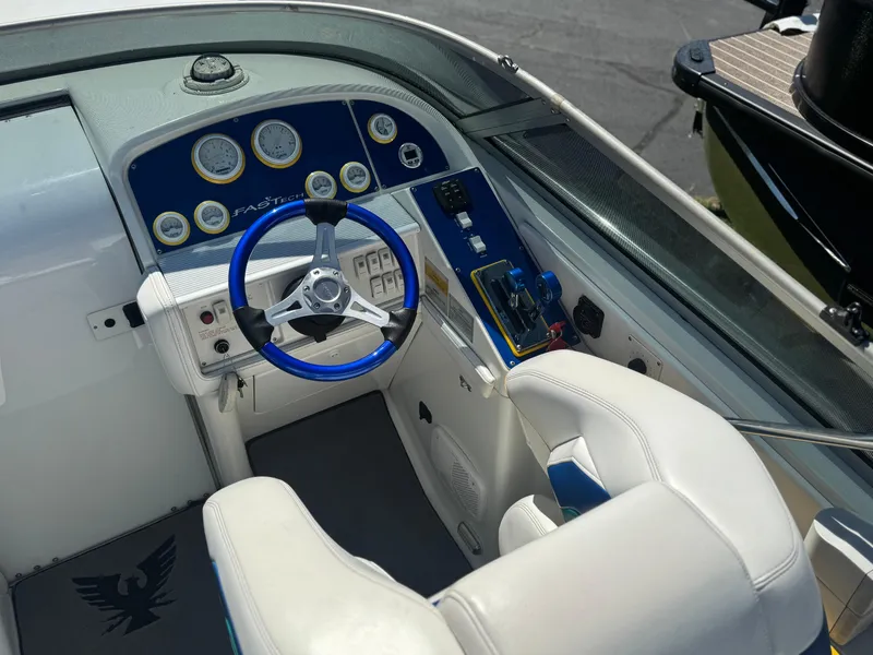 Slide: The Image of Cockpit of a 2000 Formula 271 FASTech boat with blue steering wheel and gauges. - 5