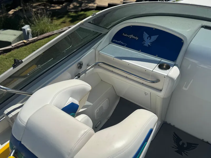 Slide: The Image of Interior of a 2000 Formula 271 FASTech boat with white seating and blue accents. - 6