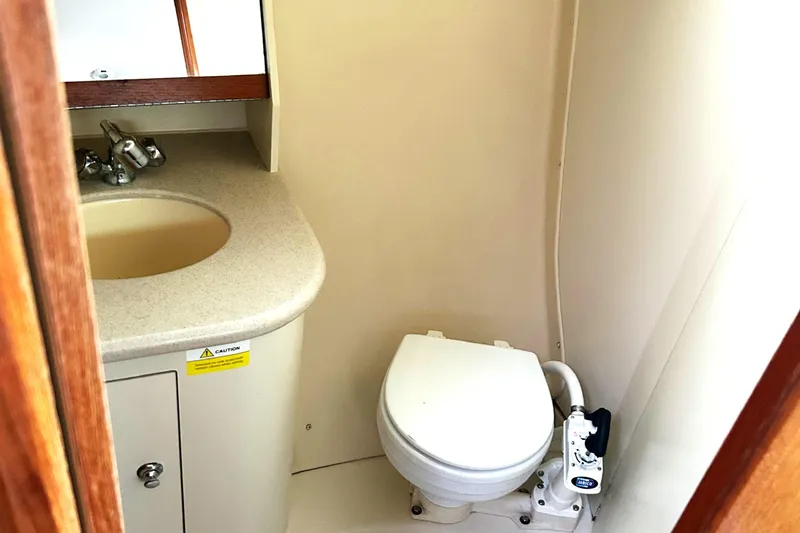Slide: The Image of Compact bathroom in 2005 Hunter 33 sailboat with sink and marine toilet. - 11