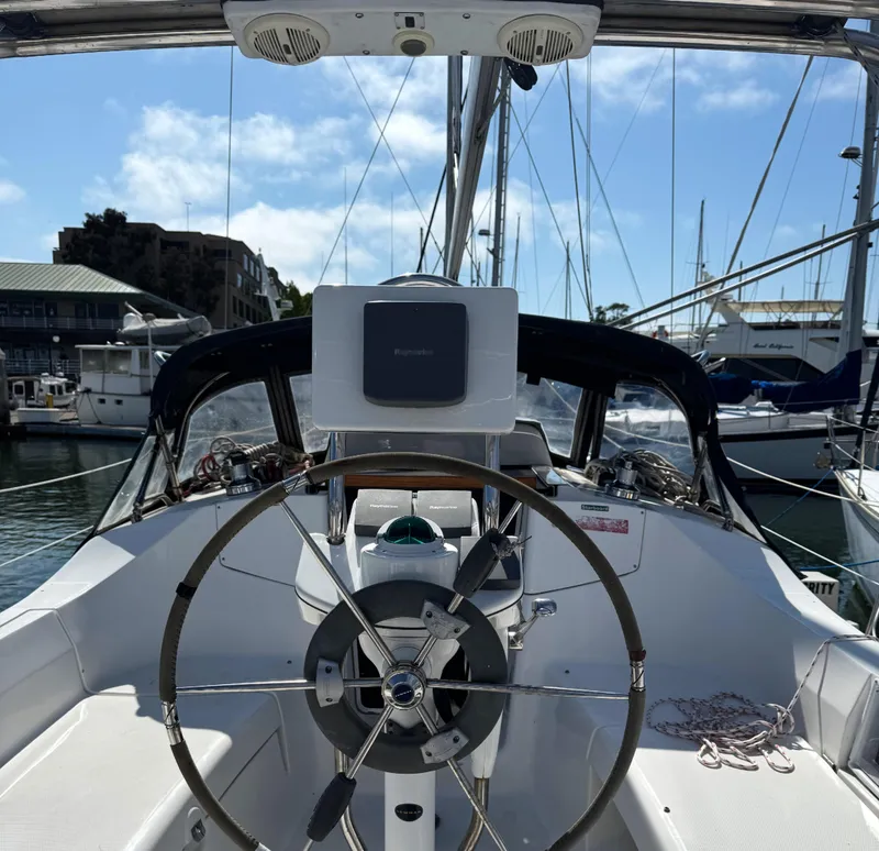 Slide: The Image of Cockpit view of a 2005 Hunter 33 sailboat with steering wheel and navigation equipment. - 3