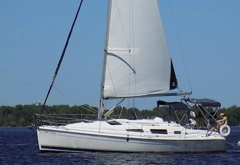 Slide: The Image of 2005 Hunter 33 sailboat on calm water with clear blue sky. - 5