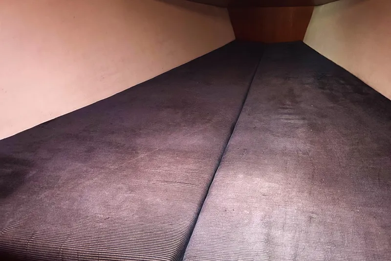 Slide: The Image of Interior cabin view of a 2005 Hunter 33 sailboat, featuring a spacious sleeping area. - 9