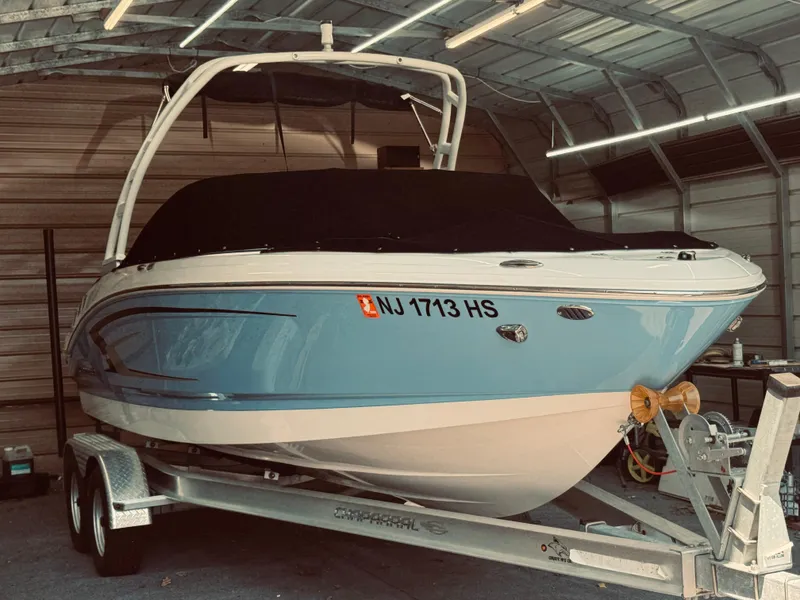 Slide: The Image of 2023 Chaparral 21 SSi OB boat on trailer in a garage. - 0