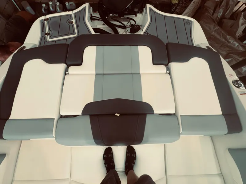 Slide: The Image of 2023 Chaparral 21 SSi OB boat interior with gray and white seating. - 11