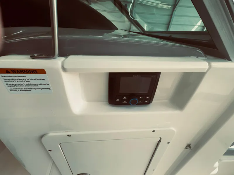 Slide: The Image of 2023 Chaparral 21 SSi OB boat dashboard with control panel and warning label. - 18