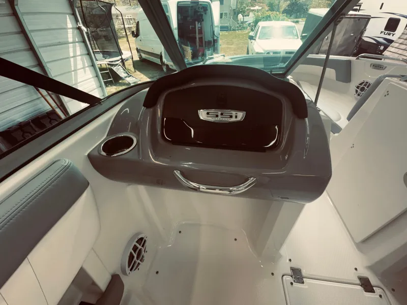 Slide: The Image of 2023 Chaparral 21 SSi OB boat interior with dashboard and seating area. - 19