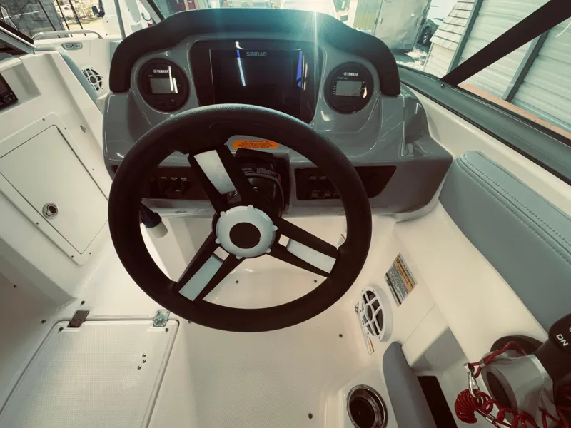 Slide: The Image of 2023 Chaparral 21 SSi OB boat dashboard with steering wheel and controls. - 20