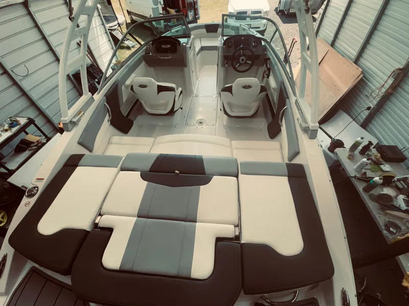 Slide: The Image of 2023 Chaparral 21 SSi OB boat interior with modern seating and steering wheel. - 21