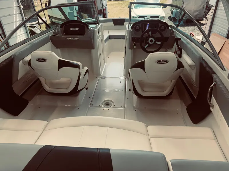 Slide: The Image of 2023 Chaparral 21 SSi OB boat interior with modern seating and steering console. - 22