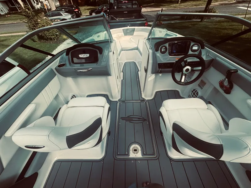 Slide: The Image of 2023 Chaparral 21 SSi OB boat interior with dual seating and modern dashboard. - 27