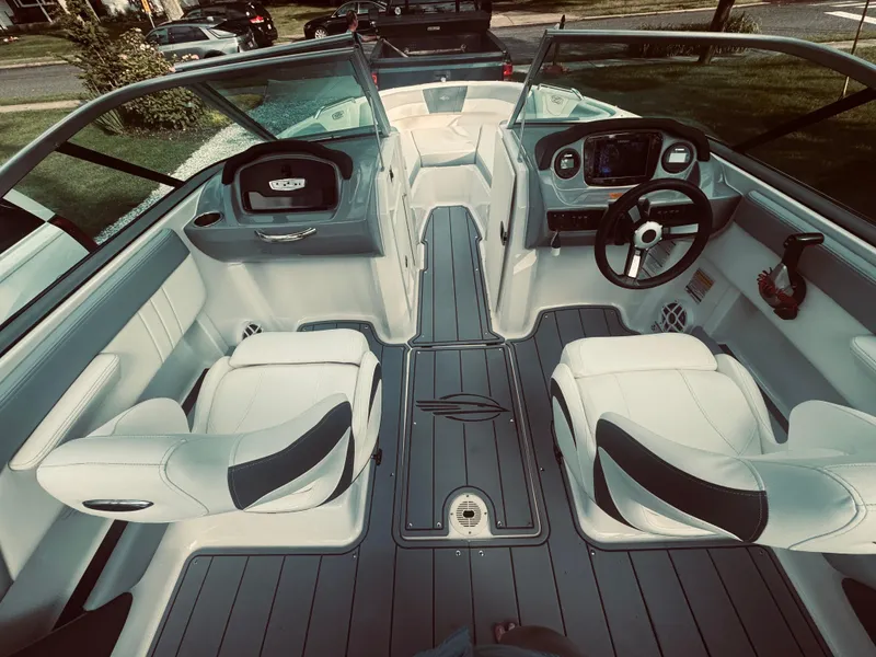 Slide: The Image of 2023 Chaparral 21 SSi OB boat interior with modern seating and dashboard. - 29