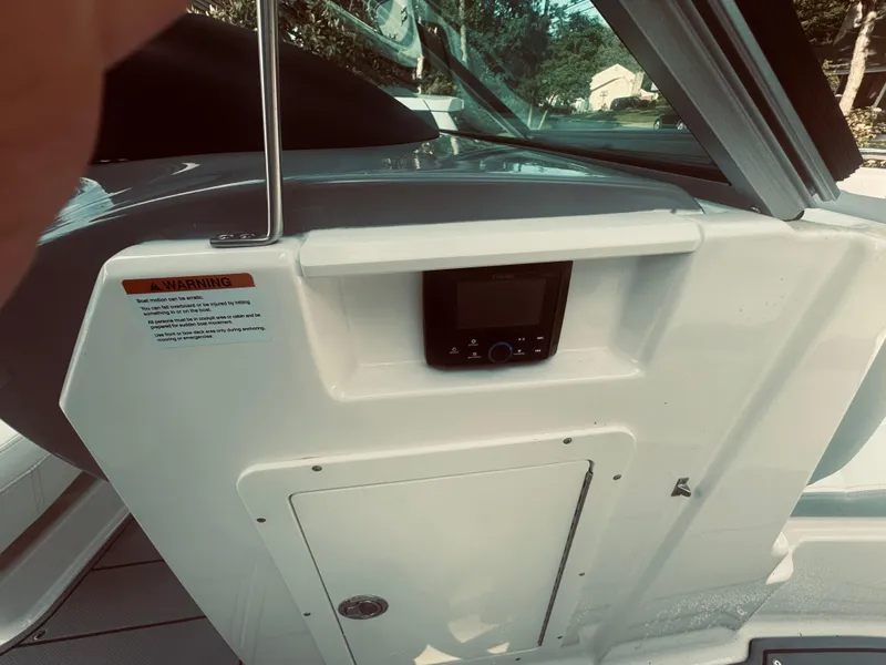 Slide: The Image of 2023 Chaparral 21 SSi OB boat dashboard with control panel and storage compartment. - 30