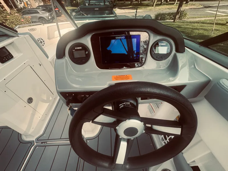 Slide: The Image of 2023 Chaparral 21 SSi OB boat dashboard with steering wheel and navigation display. - 31