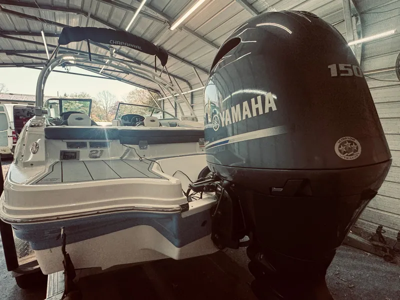 Slide: The Image of 2023 Chaparral 21 SSi OB boat with Yamaha 150 outboard engine in a garage. - 8