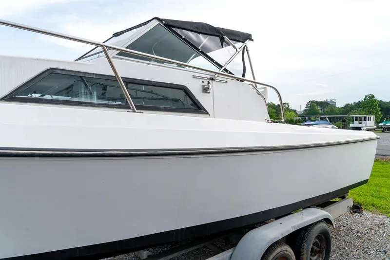 Slide: The Image of 1986 Aquasport 250 Express Fisherman boat on trailer, side view. - 11