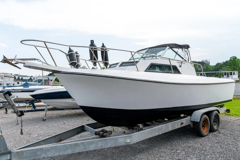 Slide: The Image of 1986 Aquasport 250 Express Fisherman boat on trailer, parked outdoors. - 12