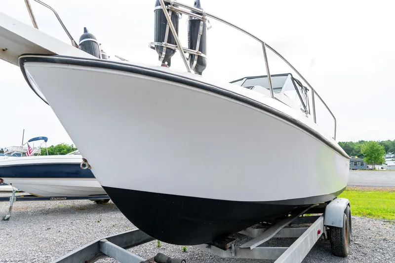 Slide: The Image of 1986 Aquasport 250 Express Fisherman boat on trailer, side view. - 13