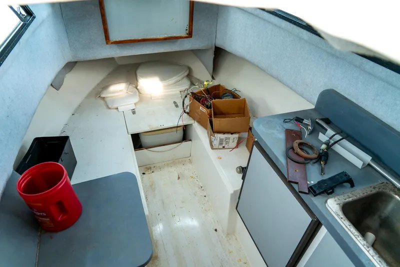 Slide: The Image of 1986 Aquasport 250 Express Fisherman cabin interior with sink and storage. - 24