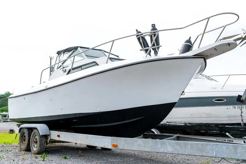 Slide: The Image of 1986 Aquasport 250 Express Fisherman boat on trailer, side view. - 3
