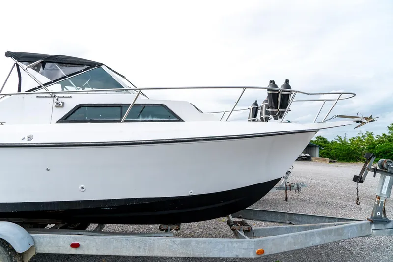 Slide: The Image of 1986 Aquasport 250 Express Fisherman boat on trailer, side view. - 5